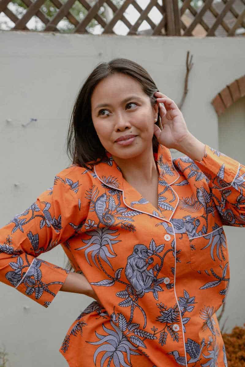 Person wearing orange organic cotton pyjamas