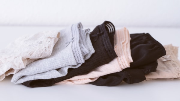 Several pairs of folded underwear, ready for recycling.