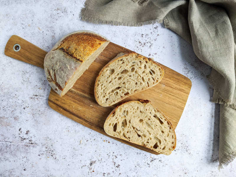 Sourdough bread on a chopping board - celebrating Sourdough September - an awareness day educating us on the benefits of sourdough bread.