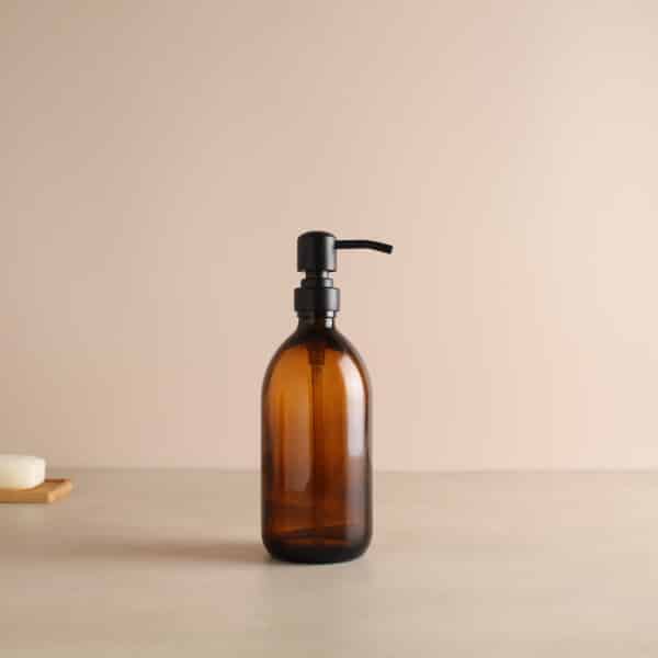 Amber glass liquid soap bottle with black metal dispenser.